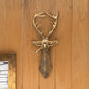 A brass deer head storage hook wall decor featuring antlers mounted on a wooden panel.