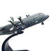 A detailed diecast model of a U.S. Air Force C-130 Hercules aircraft in gray.