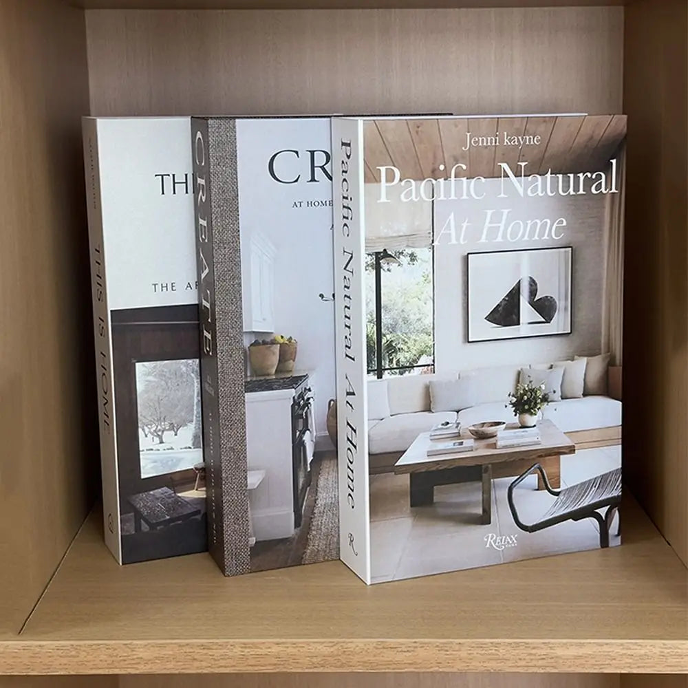 A display of the Jenni Kayne Pacific Natural At Home book featuring interior scenes and design elements.