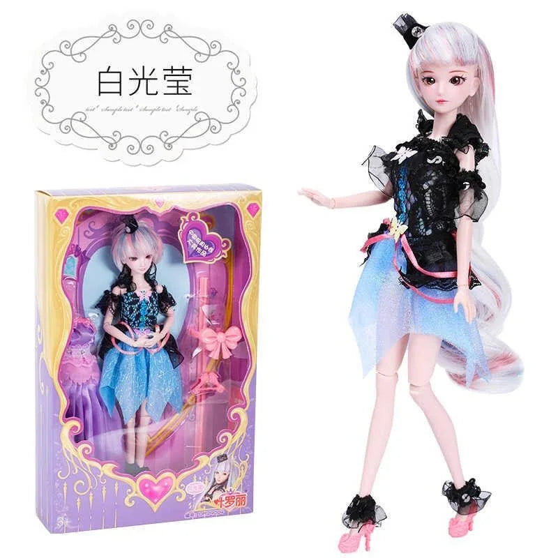 A detailed ball-jointed doll with pink hair and a black and blue outfit displayed in its packaging.