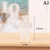 Clear glass miniature vase and wine bottle set on a wooden surface