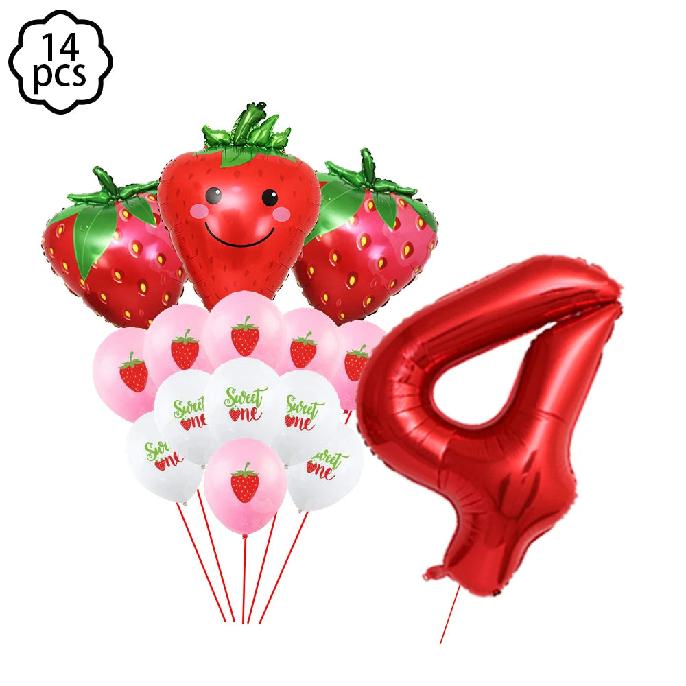 A kit of strawberry-themed party supplies including strawberries, balloons, plates, cups, napkins, and a tablecloth.