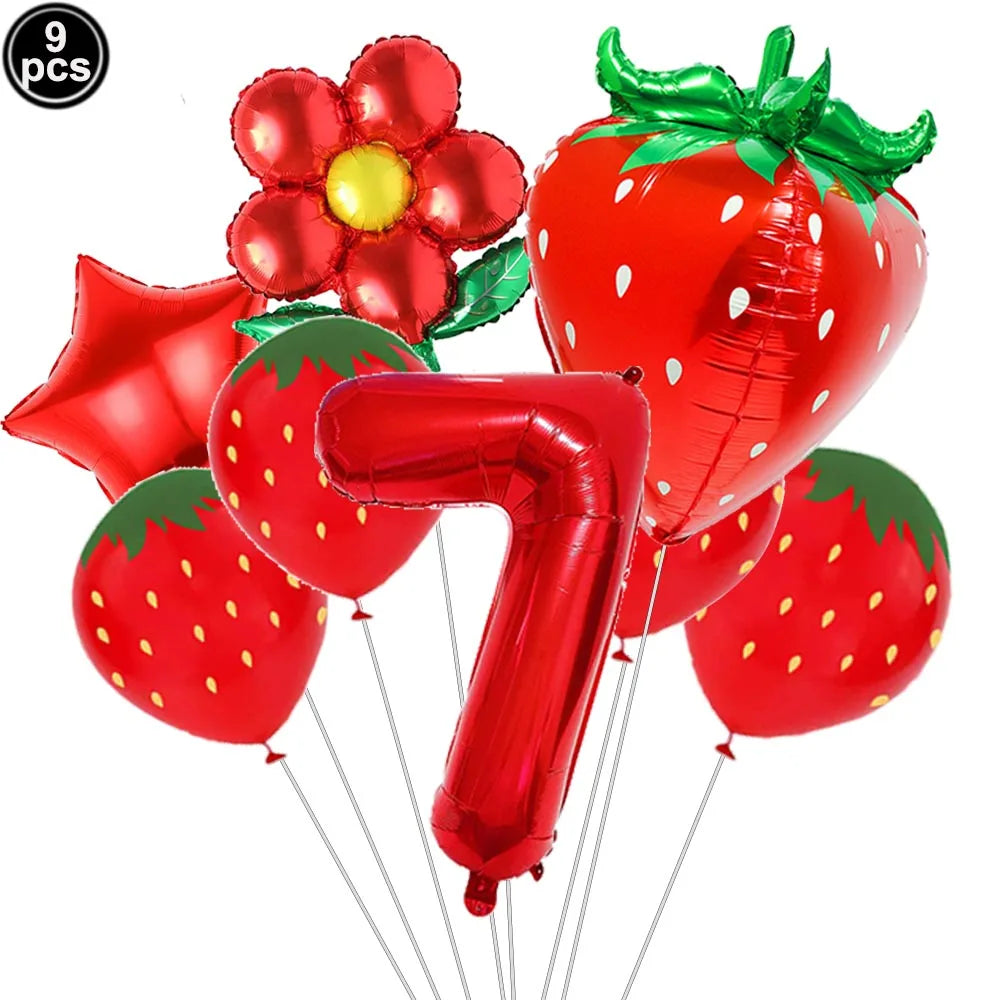 A set of red strawberry shaped balloons and a number seven balloon for a party kit