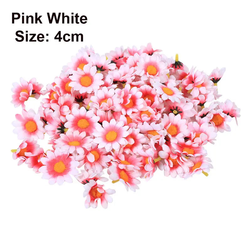 A pile of pink and white artificial sunflower and daisy heads for DIY and wedding decor.