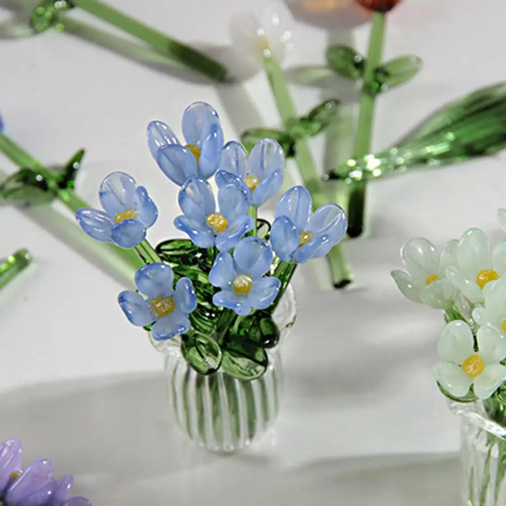 A small bouquet of hand-blown glass flowers in shades of blue and white.