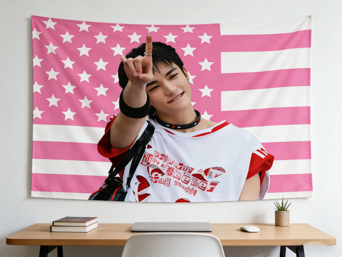 A person holds up a pink American flag tapestry featuring stars and stripes against a white background.