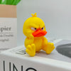 A yellow 3D printed figurine of an angry duck with orange beak and glaring eyes.