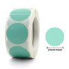 Roll of heart-shaped seal stickers in mint green and white on a white background