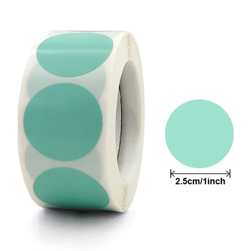 Roll of heart-shaped seal stickers in mint green and white on a white background
