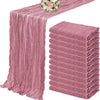 A set of ten terracotta semi-sheer cheesecloth table runners in a dusty rose color displayed on a table.