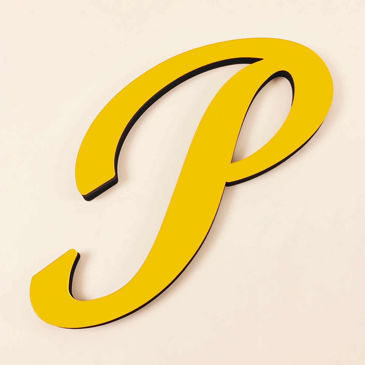 A yellow 3D acrylic letter P wall sticker against a light background.