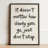 A framed black and white motivational quote print on a white background with handwritten text.