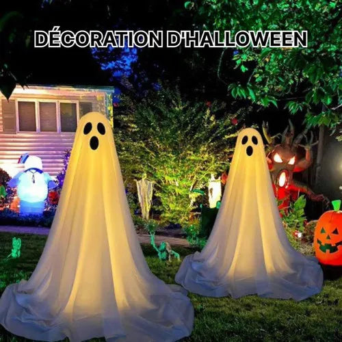 A white ghost decoration with an LED light is displayed outdoors in a Halloween themed setting.