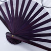A dark purple folding hand fan with radiating slats and a wooden handle is shown against a white background.