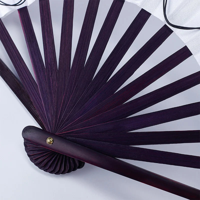A dark purple folding hand fan with radiating slats and a wooden handle is shown against a white background.