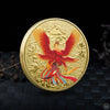 A gold collectible coin featuring a fierce red mythical bird with outstretched wings and intricate patterns.