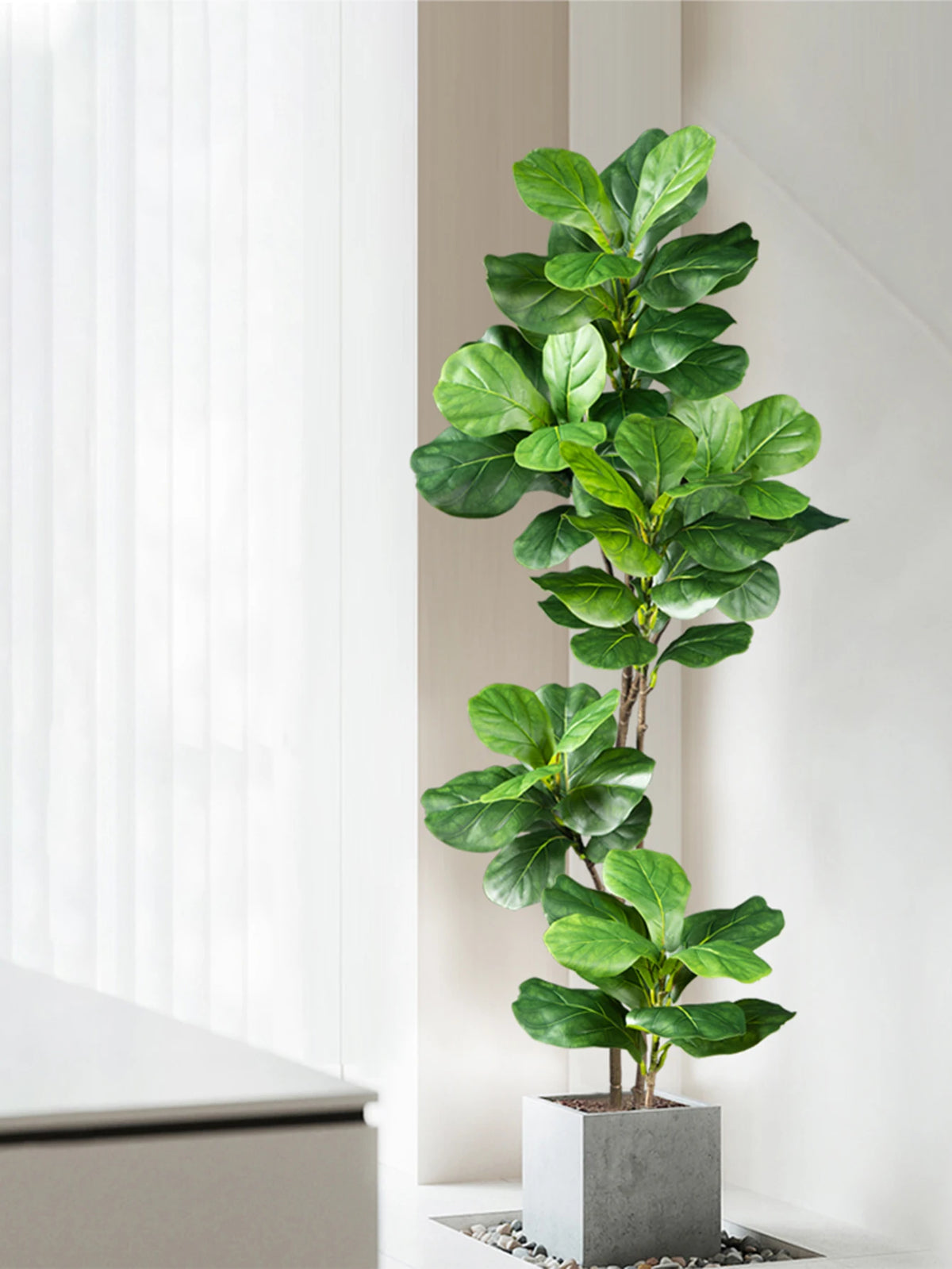 A large artificial ficus tree with green fiddle leaves potted in a gray square planter.