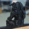 A dark, textured figurine of an Interstellar Hunter in a sci-fi style, displayed on a surface.