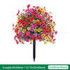 A vibrant bouquet of artificial petunias in various shades of pink, red, and yellow arranged on a ground stake.