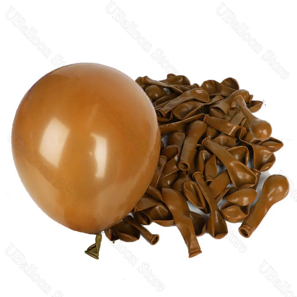 A pile of brown latex balloons in neutral shades for baby shower and birthday décor.