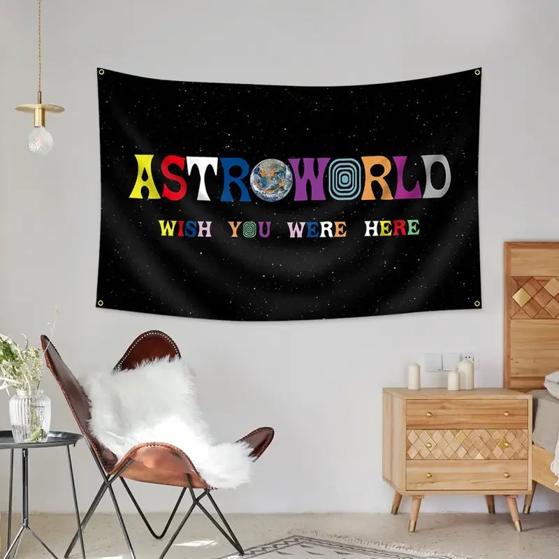 A black tapestry wall hanging featuring the text ASTROWORLD and WISH YOU WERE HERE in colorful letters.