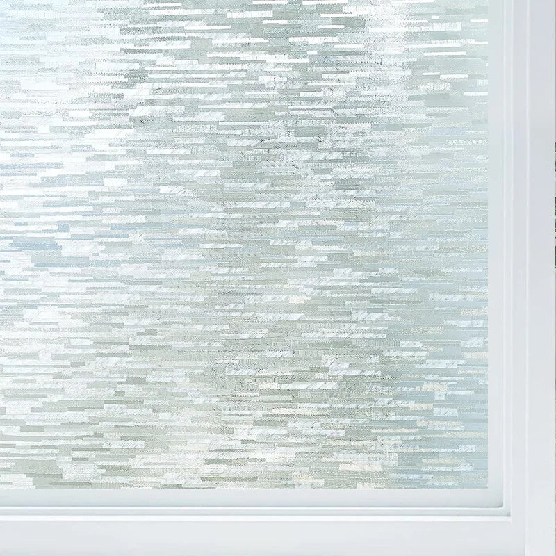 Close-up of frosted glass window privacy film with a light blue and white striped pattern.