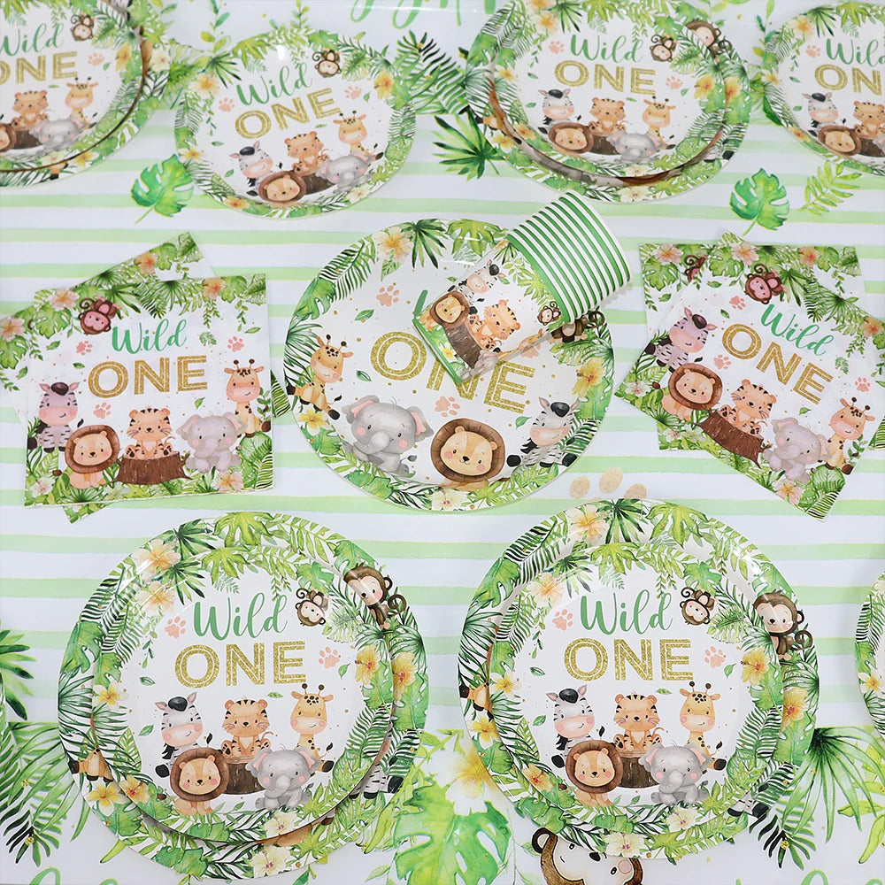 Green and white patterned tableware set featuring wildlife and jungle themes for a birthday party.