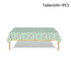 A light mint green tablecloth with a pink floral pattern displayed on a wooden table.