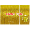 Three panels of gold glitter metallic foil fringe curtains used for party backdrop decor