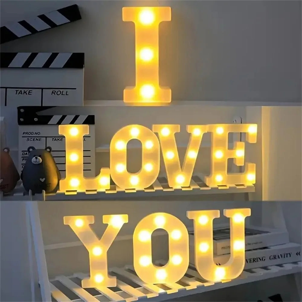 A display of glowing LED letter lights spelling out I LOVE YOU on a shelf.
