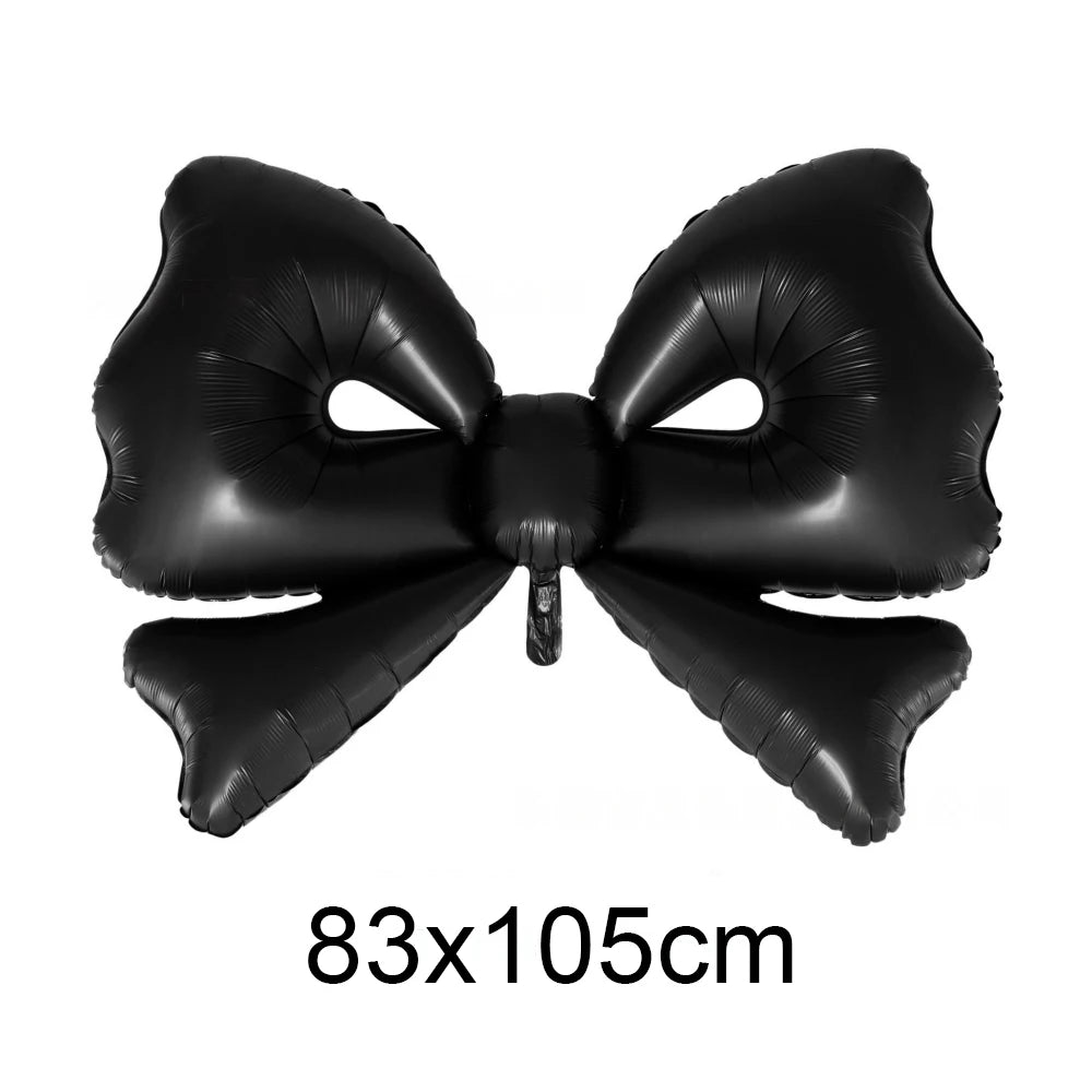 Black foil bow shaped like a cupcake topper for birthday or bridal shower