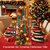 A festive Christmas table setting featuring red linens, green napkins, and tall candles with flickering flame effects.
