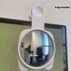 A white adjustable 360 degree convex mirror mounted on a wall, reflecting an office interior.
