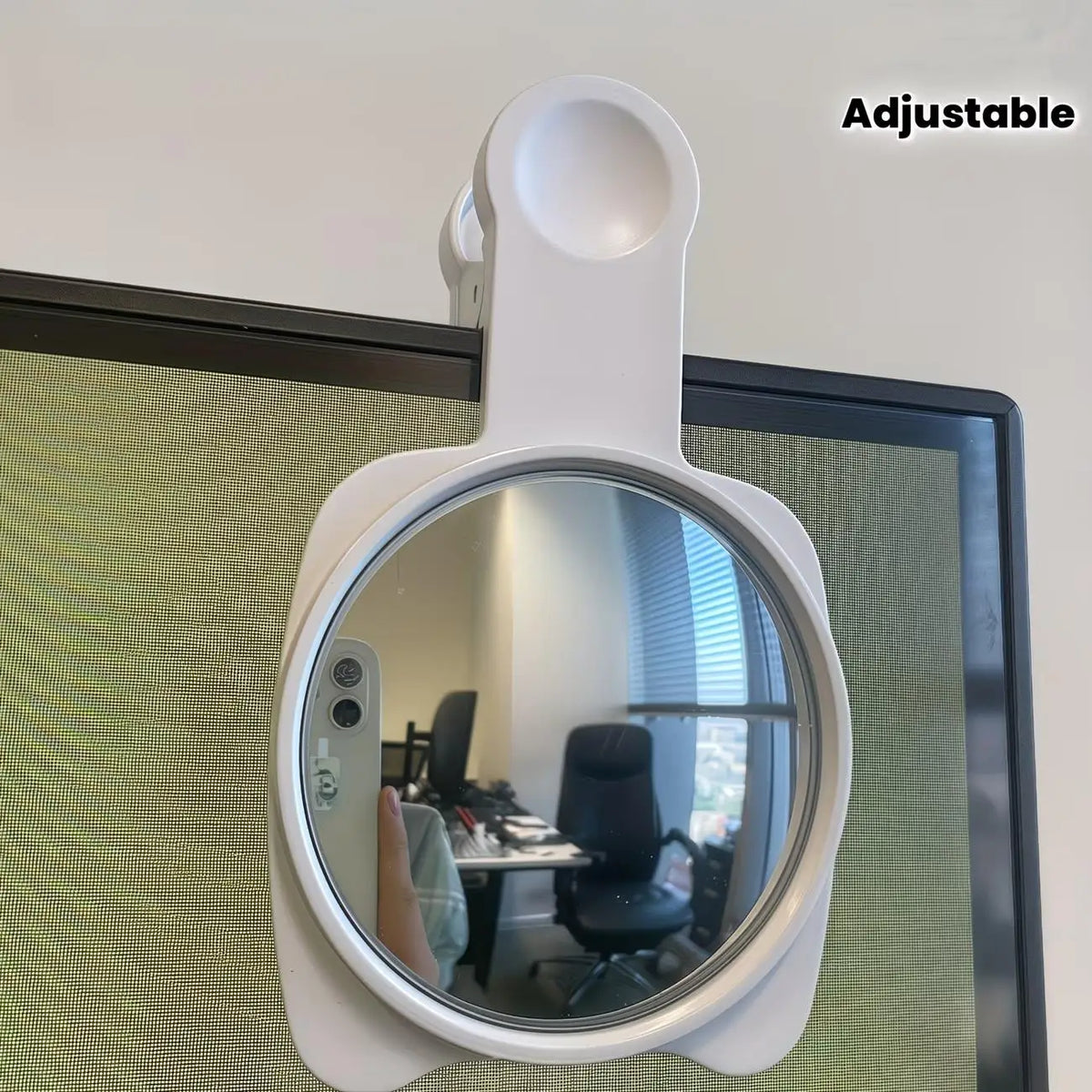 A white adjustable 360 degree convex mirror mounted on a wall, showing a desk and office interior.