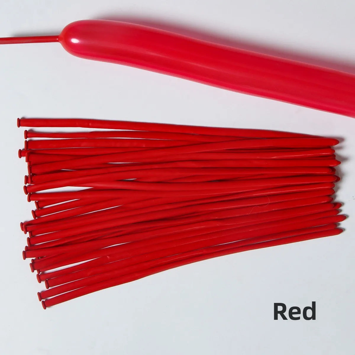 A collection of red latex strip balloons and a long red balloon are displayed on a white background.