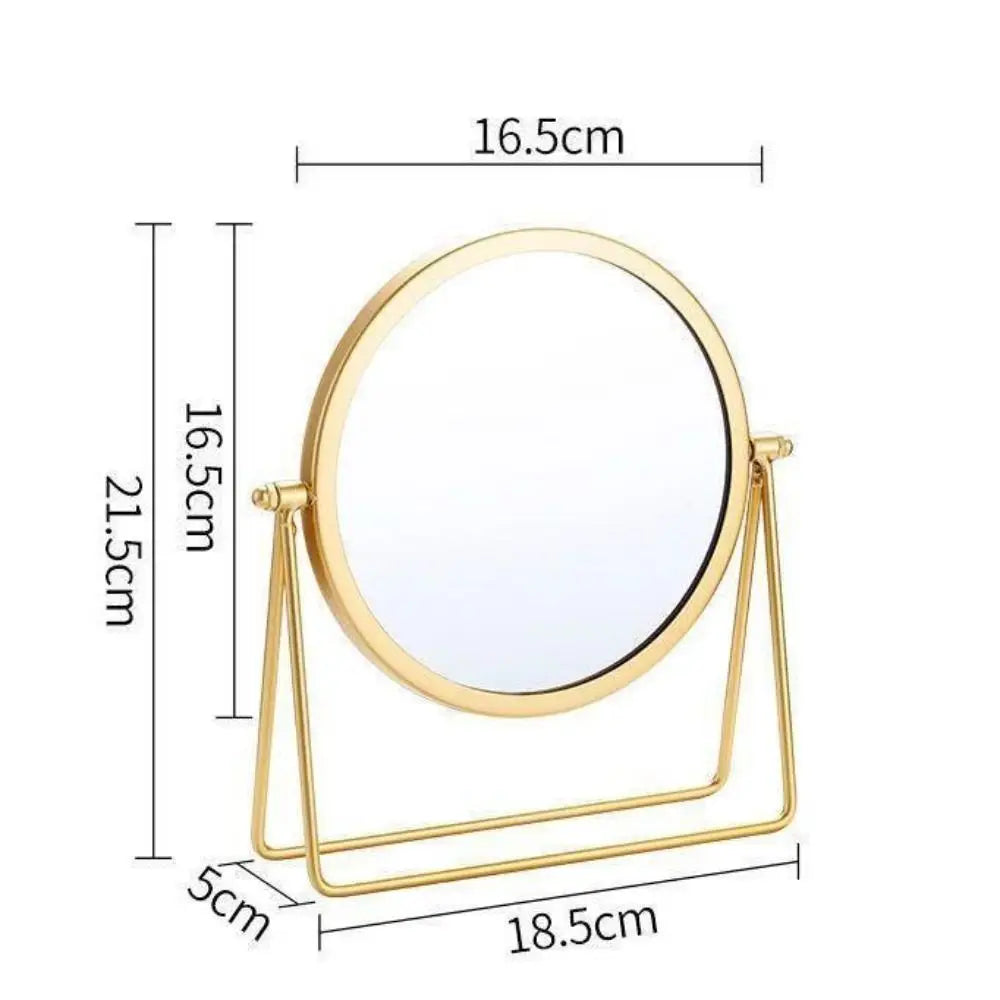 A round, gold-colored metal makeup mirror with a stand, shown with dimensions.