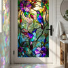 Stained glass window film featuring colorful hummingbirds and floral designs on a door panel.