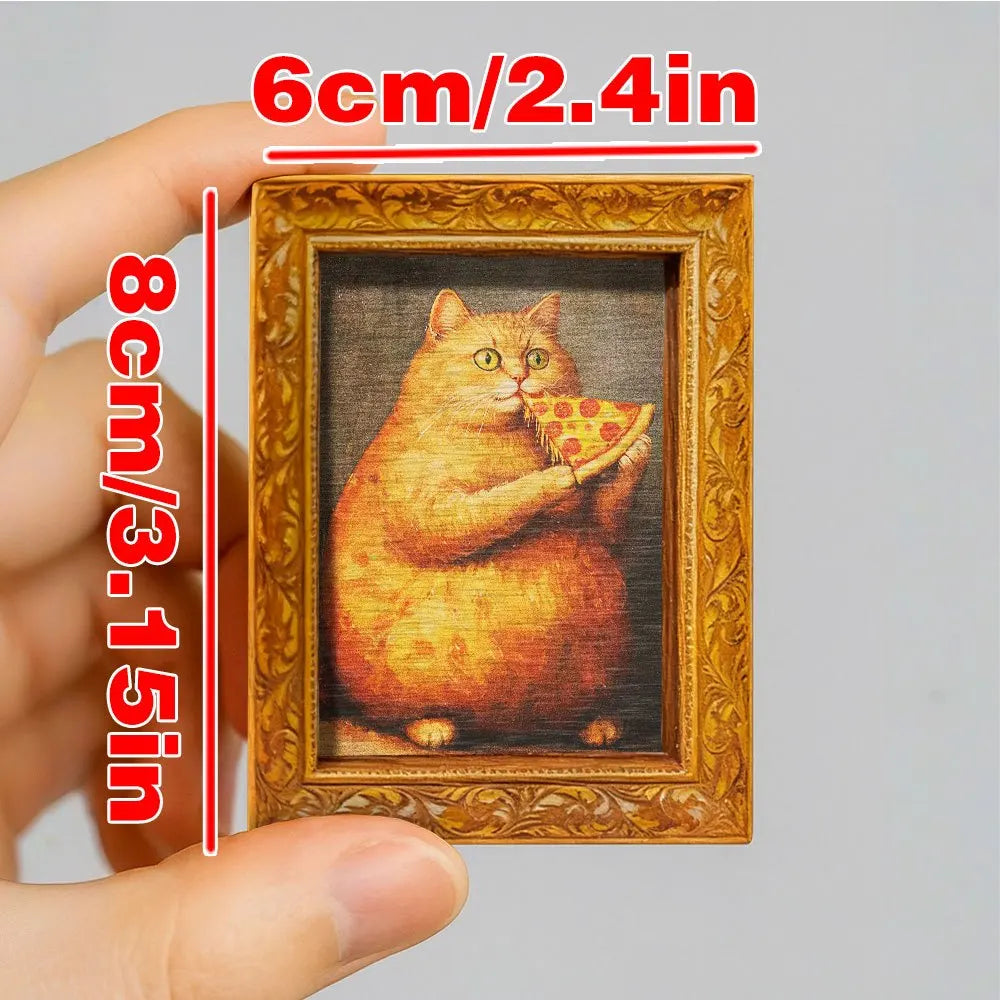 A framed picture of an orange cat eating a slice of pizza, displayed in a wooden frame.