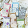 A collection of vintage old English manuscript decor paper sheets in various pastel and muted tones.