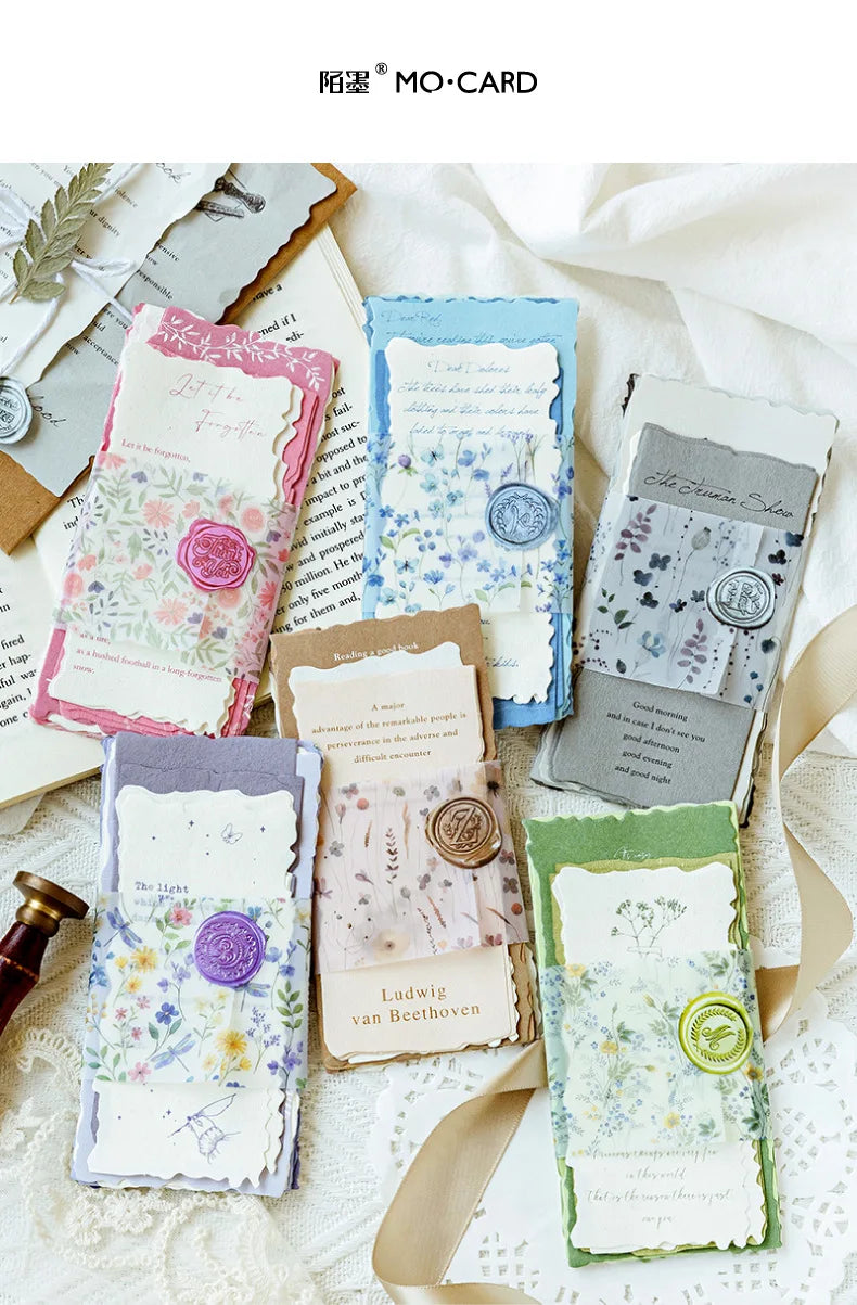 A collection of vintage old English manuscript decor paper sheets in various pastel and muted tones.