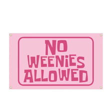 A pink rectangular sign with the text NO WEENIES ALLOWED in large, bold, pink letters.