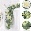 A long artificial eucalyptus garland featuring white roses and gypsophila for floral decoration.