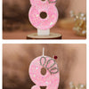 Two pink glitter birthday candles shaped like the numbers 8 and 9 with crown toppers