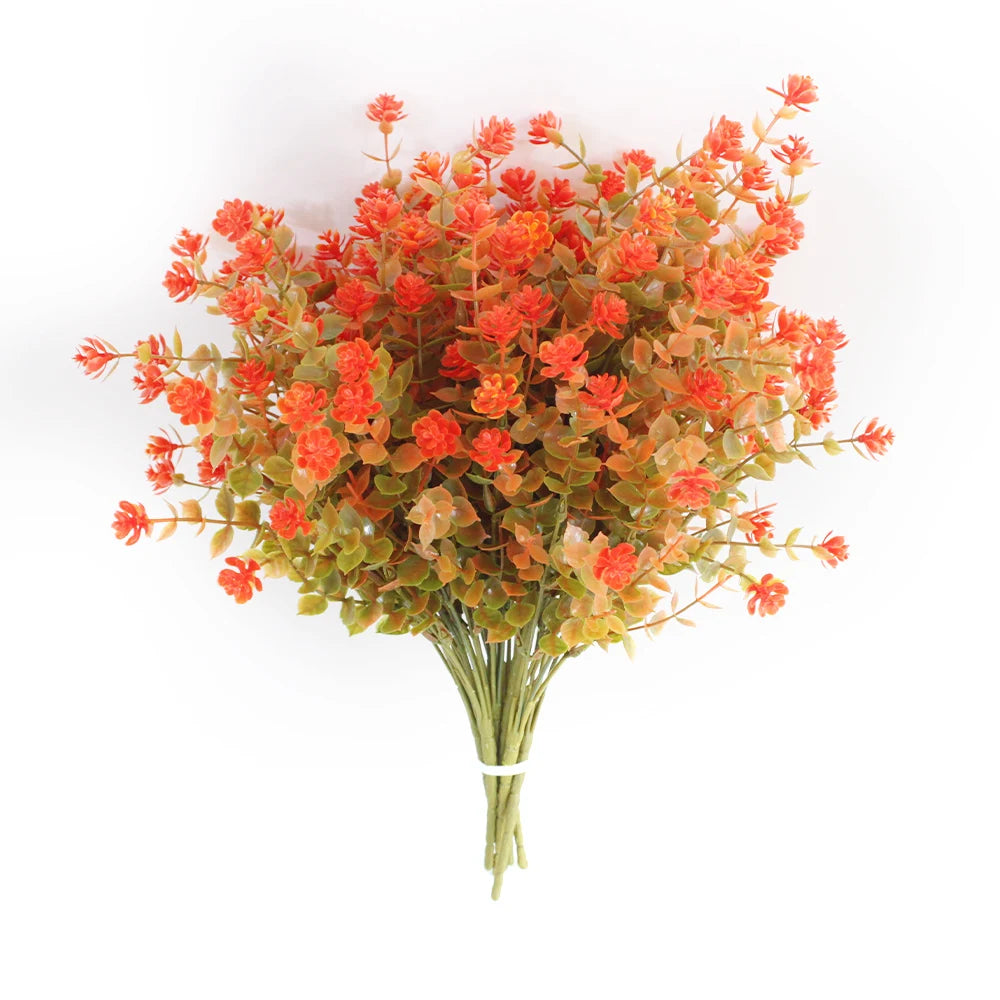 A bouquet of artificial orange and green eucalyptus and flower stems for outdoor decor.