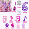 Purple music theme birthday party decorations including balloons, musical instruments, and props