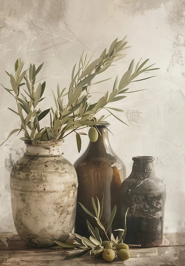 A still life featuring olive branches and green fruit in antique glass bottles against a textured, light background.