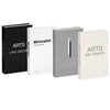 A set of three minimalist decorative faux books in black, white, and gray for home decor