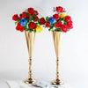 A bouquet of red, blue, and yellow roses displayed in elegant golden silver wedding flower vases.