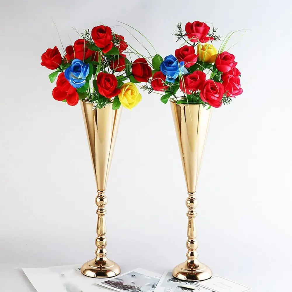 A bouquet of red, blue, and yellow roses displayed in elegant golden silver wedding flower vases.