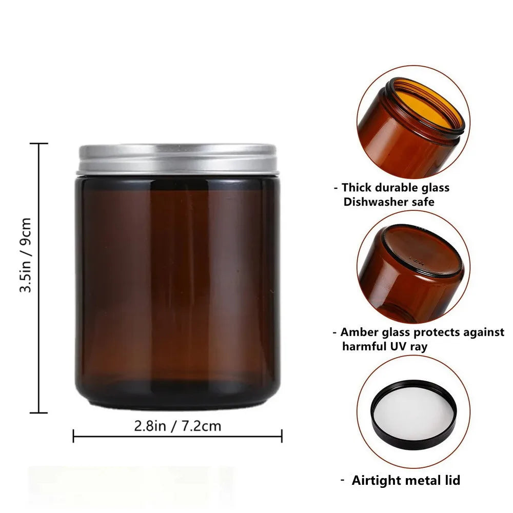 A set of two amber glass candle jars with airtight metal lids shown next to a measurement scale.